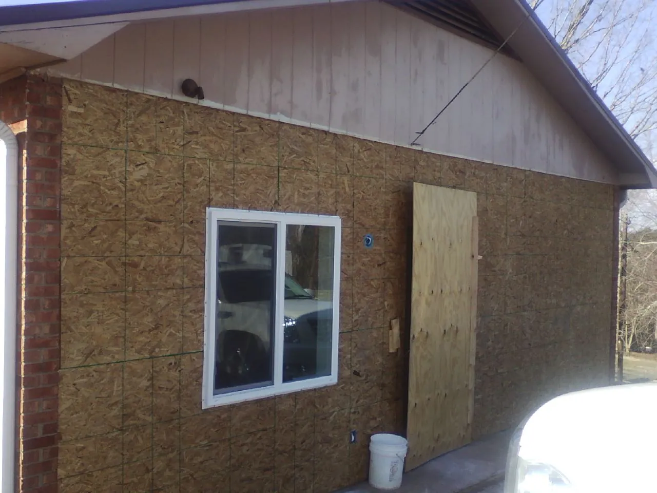 OSB sheathing on a garage addition wall before siding in Marion